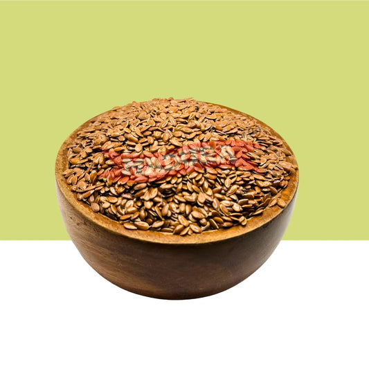 A wooden bowl filled with brown Wooden Flax Seed, centered against a split background with a light olive-green upper half and white lower half.