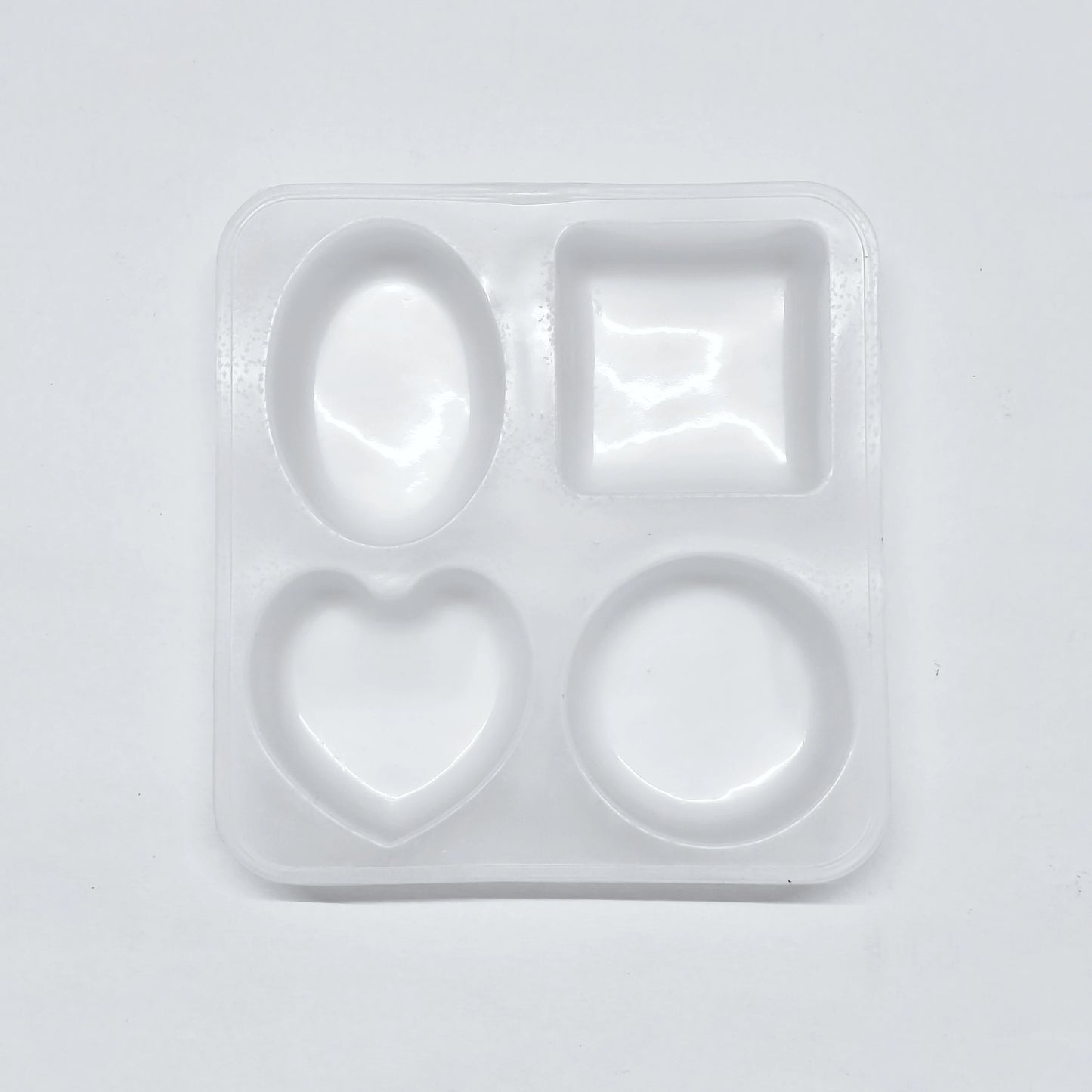 Set of silicone molds with different shapes on a light gray background