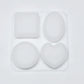Set of four white silicone molds on a light gray background