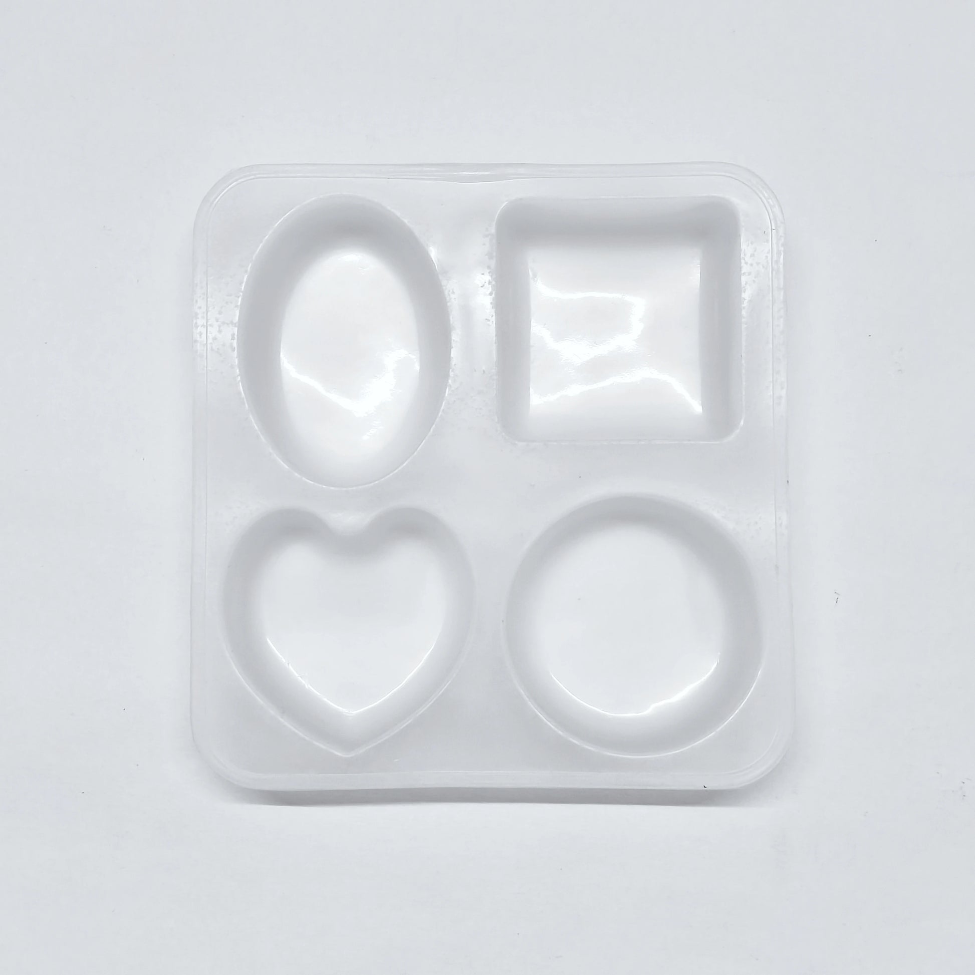 Set of silicone molds with different shapes on a light gray background