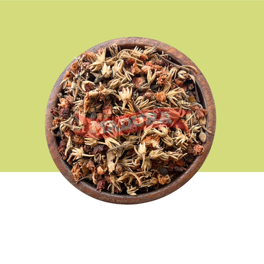 Wooden bowl filled with dried herbs and Magilampoo Raw on a green background
