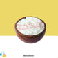Wooden bowl filled with white powder labeled 'Malto Dextrin' on a yellow background