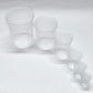 Set of clear plastic measuring cups on a white background
