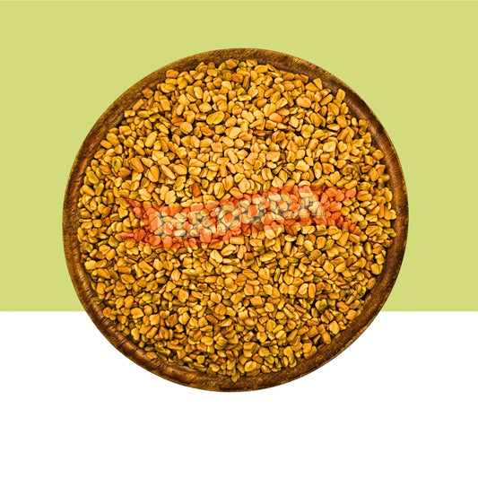 A top-down view of a round wooden bowl filled with small golden-brown dried seeds or grains, set against a split background of light green on the upper half and white on the lower half.